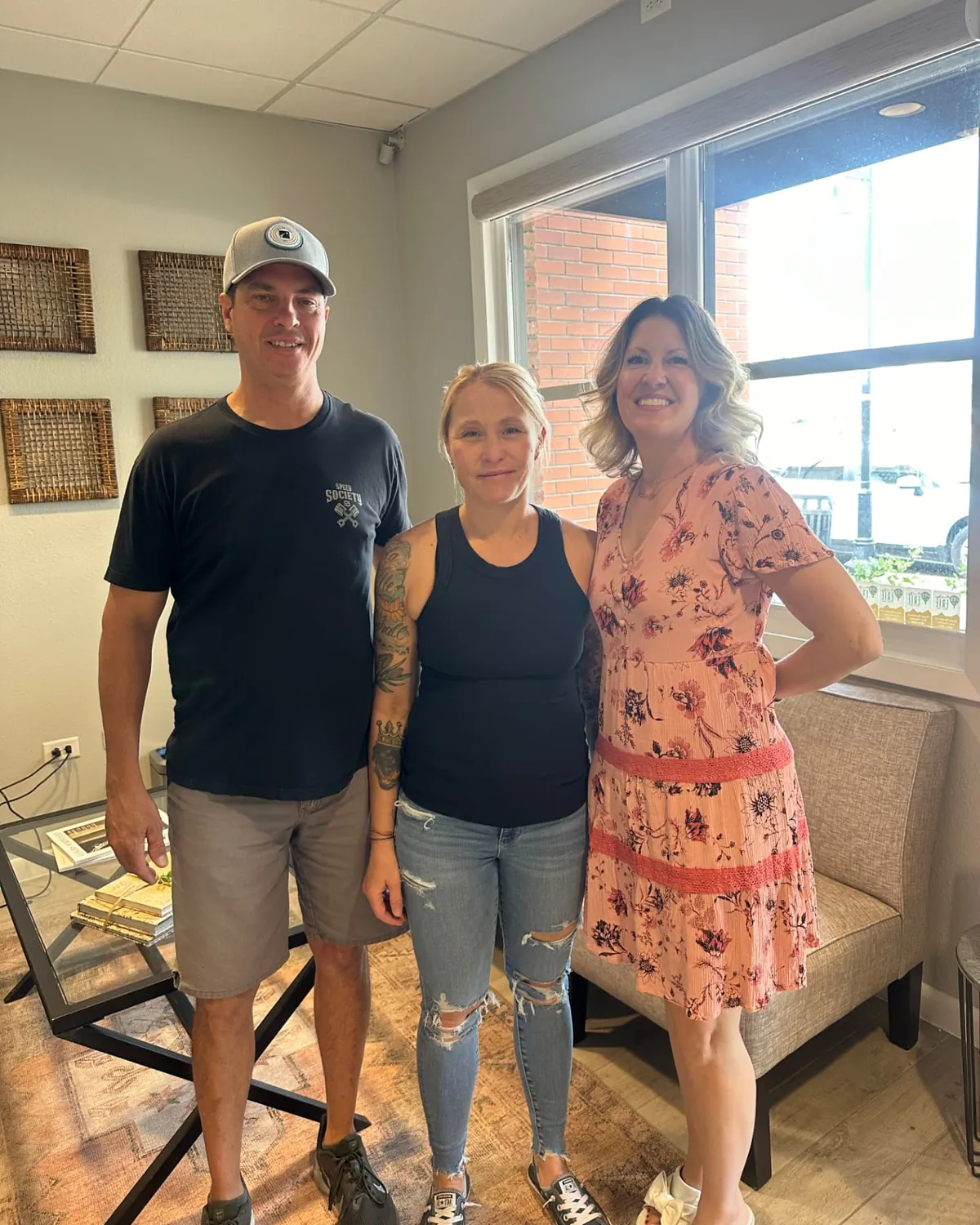 Brandy Unruh, REALTOR® with Compass, with happy buyers at a Colorado closing