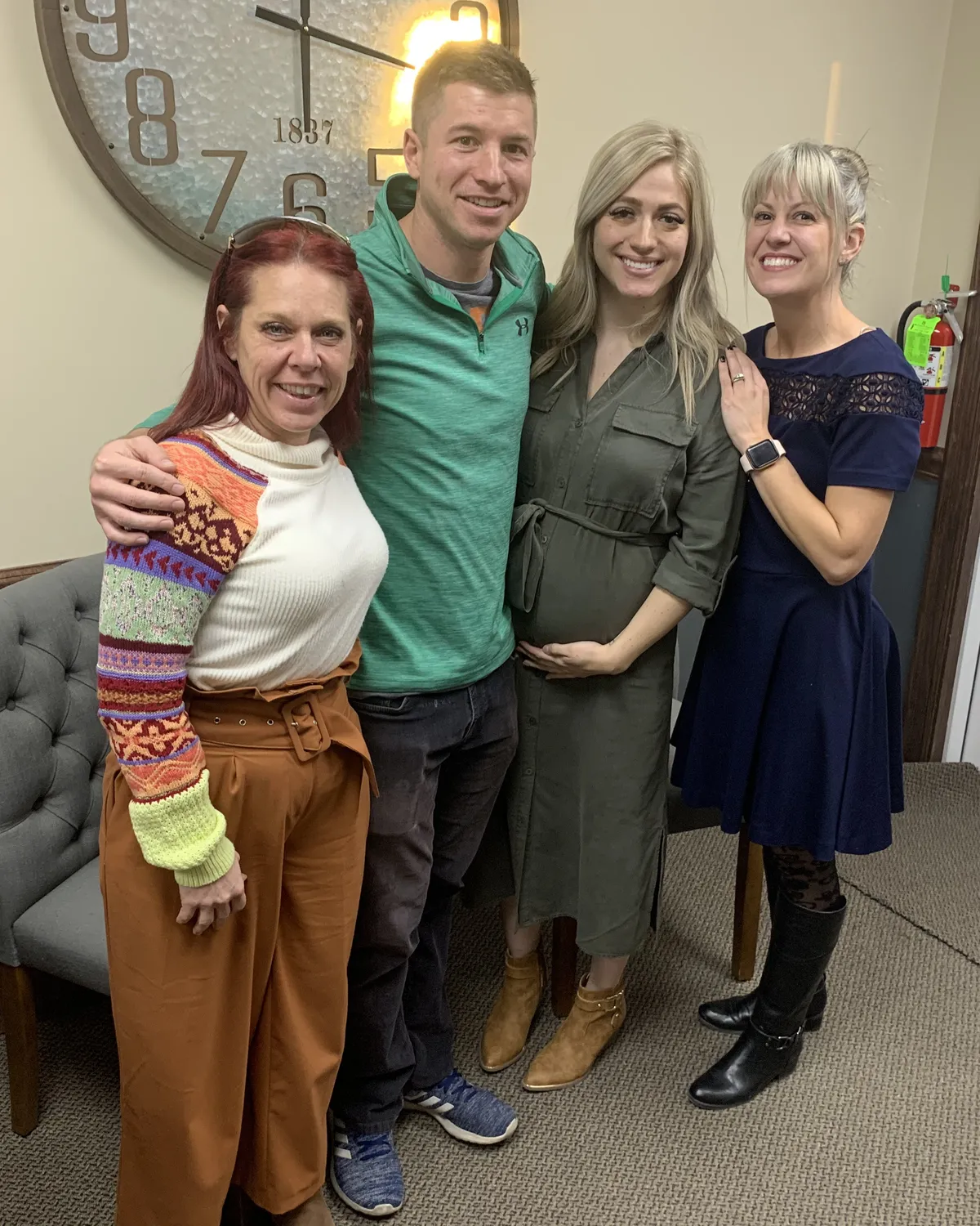 Brandy Unruh, REALTOR® with Compass, with a happy group of clients at a Colorado closing